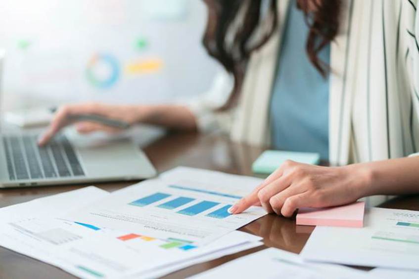 A person pointing at a graph on a paper
AI-generated content may be incorrect.